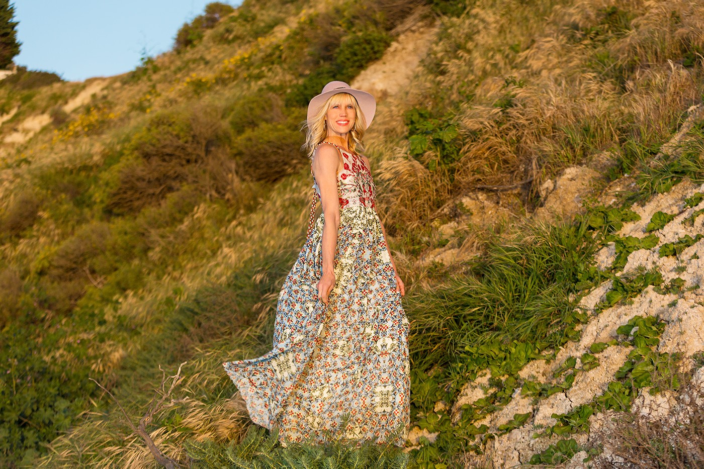 Anthropologie dress and Michael Stars hat on hillside at the beach